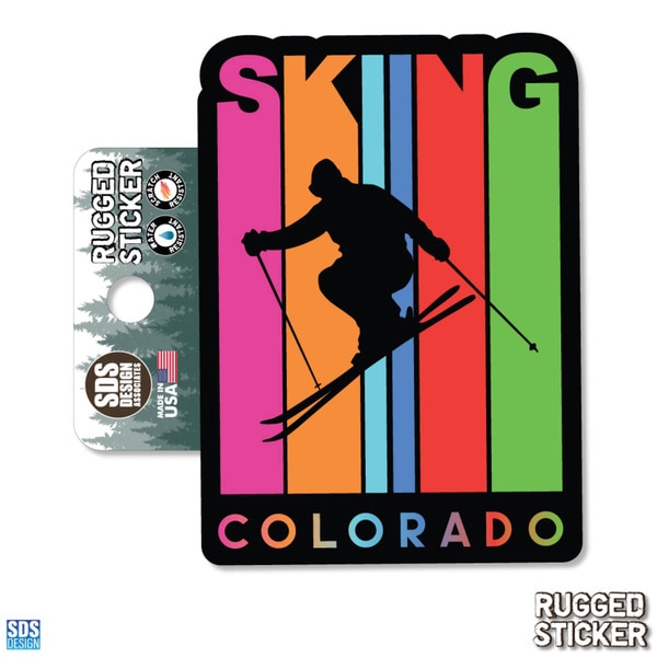 Rugged sticker with a silhouette of a skier jumping in front of vertical rainbow stripes, featuring the words “SKIING COLORADO.”